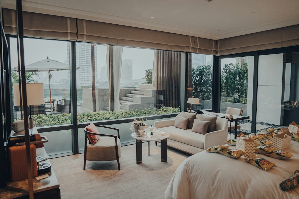 Warm wood-paneled full-service hotel lobby with marble flooring, upholstered lounge seating and elevator vestibule - the long-lived assets that compete for capital on every hotel renovation list